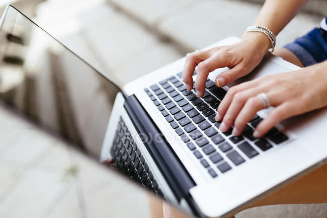 focused_173718416-stock-photo-hands-woman-typing-keyboard-laptop